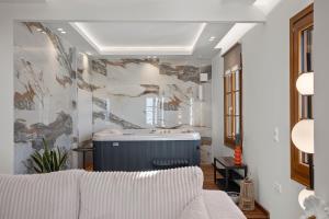 a living room with a tub in the middle at Pnoe Luxe Apartment & Spa, Naxos Town in Naxos Chora +127 photos