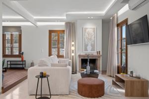 a living room with a couch and a fireplace at Pnoe Luxe Apartment & Spa, Naxos Town in Naxos Chora