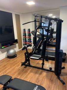 um quarto com um ginásio com uma passadeira e uma televisão em Melhores Flats - Tranquilo, pertinho do mar em João Pessoa