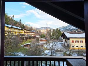 ジアーノ・ディ・フィエンメにあるAttico Lagorai - Alpine Stay Apartmentsの雪の町の景色を望むバルコニー