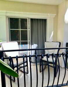 a balcony with two chairs and a table at Luxury modern retreat- next to the beach in Punta Cana