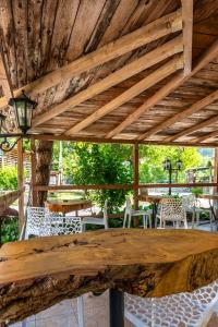 a wooden table and chairs under a wooden ceiling at La Roulotte 2 in Touët-sur-Var