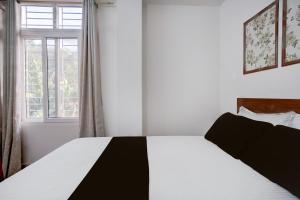 Ένα ή περισσότερα κρεβάτια σε δωμάτιο στο Hotel O La Vita Oasis +21 φωτογραφίες