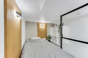 a bedroom with a bed and a sliding door at City Apartments in Tallinn