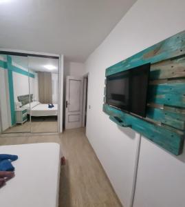 a living room with a flat screen tv on a wall at La mariposa in Parque Holandes