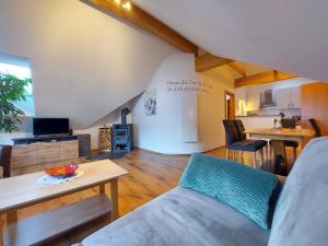 a living room with a couch and a table at Penthouse Aineckblick in Sankt Margarethen im Lungau