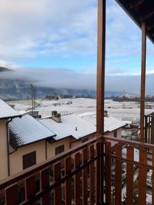 a view from the balcony of a house with snow covered roofs at Maison della Presolana in Songavazzo