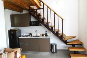 a kitchen with a sink and a staircase at Loft Moderno a Pasos de la Playa con Piscina by Caribbean Paradise Rentals in Bayahibe