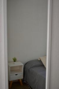 a bedroom with a bed and a white night stand at Casita en el centro de Oaxaca cerca de Santo Domingo in Oaxaca City