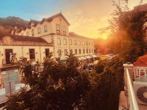a group of buildings on a street with the sun setting at Happy Holiday Sintra in Sintra +66 photos