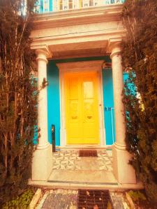a yellow door on a blue house at Happy Holiday Sintra in Sintra