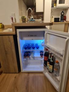 an open refrigerator in a kitchen with bottles of wine at Haides helle Wohnung in Neckarsteinach