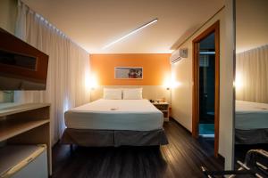 a hotel room with a bed and a mirror at ibis Styles Belem Batista Campos in Belém +44 photos