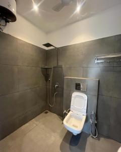 a bathroom with a white toilet in a room at Sky s whiye house in Ludhiana