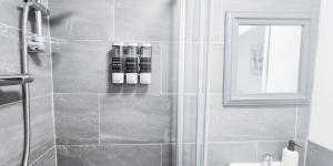 a bathroom with a shower with a glass door at The Burford Hideaway in Nottingham