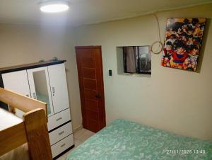 a bedroom with a bed and a dresser and a mirror at Alojamiento colibrí in San Antonio +1 photo