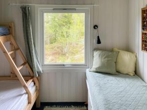 a bedroom with two bunk beds and a window at Family Cabin With Fjord Views In Drøbak Heights in Drøbak