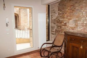 a chair in a room with a brick wall at Villa Cortellini in San Clemente