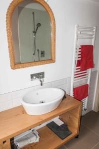 a bathroom with a white sink and a mirror at Villa Cortellini in San Clemente