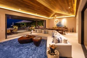 a living room with a couch and a table at Beachfront Villa with Butler and Private Pool in Punta Mita