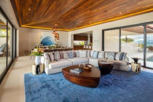 a living room with a couch and a table at Beachfront Villa with Butler and Private Pool in Punta Mita