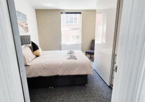 a small bedroom with a bed and a window at Stylish & Modern 2BR Flat nr Nottingham City Centre in Nottingham