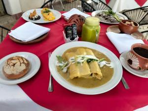 a table with a bowl of soup on a red table at HOTEL PALACIO CHATINO in Santos Reyes Nopala +7 photos