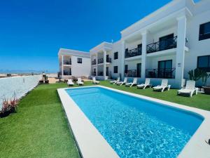 an image of a villa with a swimming pool at Ola Cotillo Beach El Cotillo in El Cotillo