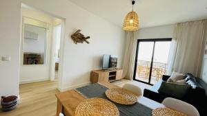 a living room with a table and a couch at Ola Cotillo Beach El Cotillo in El Cotillo