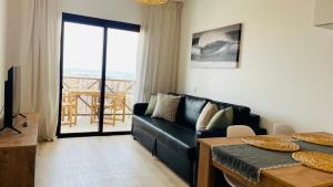 a living room with a couch and a table at Ola Cotillo Beach El Cotillo in El Cotillo