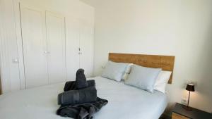 a bedroom with a bed with a chair on it at Ola Cotillo Beach El Cotillo in El Cotillo +11 photos