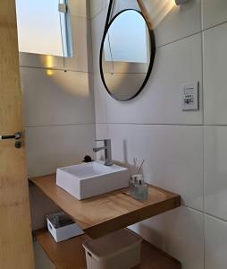 a bathroom with a white sink and a mirror at Chalé com bela vista para as montanhas in Resende +31 photos