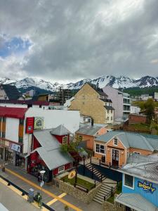 a small town with snow covered mountains in the background at Gente del Sur - Avenida in Ushuaia