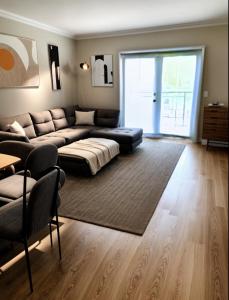 een woonkamer met een bank en een tafel en een groot raam bij Amazing Beautiful Downtown Apt in Norfolk