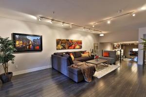 a living room with a couch and a table at Ice District 2 Kings Private Parking Patio in Edmonton