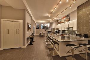 a large kitchen with a large island in the middle at Ice District 2 Kings Private Parking Patio in Edmonton