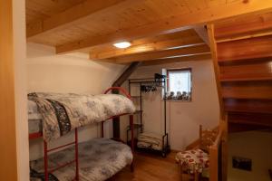 a room with two bunk beds and a staircase at La Casetta del Picchio in Caspoggio