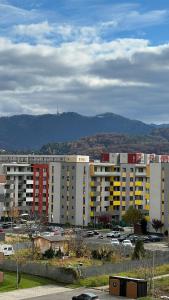 a parking lot with large buildings in a city at Luxury Avantgarden apartament in Braşov