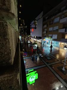 a view of a city street at night with green lights at Топ соба 2 in Niš