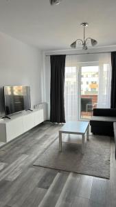a living room with a couch and a coffee table at Luxury Avantgarden apartament in Braşov