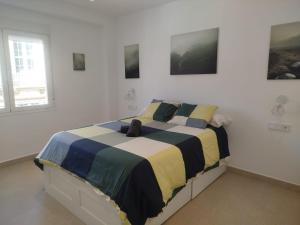 a bedroom with a bed in a white room at Nunes Luxury in Ronda