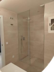 a shower with a glass door in a bathroom at Nunes Luxury in Ronda