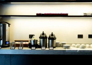 een aanrecht met potten, pannen en borden bij Hotel Palermitano by DOT Boutique in Buenos Aires