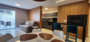 a kitchen and living room with a table and a couch at Dream Apartment-Rooftop, Pool, Mountain & Sea View in Capão da Canoa