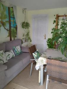 a living room with a couch and a table at Flor de Loto in Candeleda +10 photos