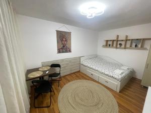 a small room with a bed and a table at Studio Modest in Craiova