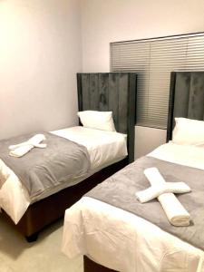 Ένα ή περισσότερα κρεβάτια σε δωμάτιο στο Serenity at Urban Space