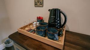 a wooden tray with cups and a blender on a counter at JUST B Townhouse in Dingle