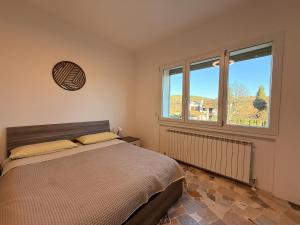 Ένα ή περισσότερα κρεβάτια σε δωμάτιο στο Casa Buda Maggiore