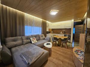 a living room with a couch and a table at Crown Apartment Lesná in Stará Lesná